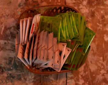 Stacks of wholesale black tea packages ready for distribution in a bright warehouse.