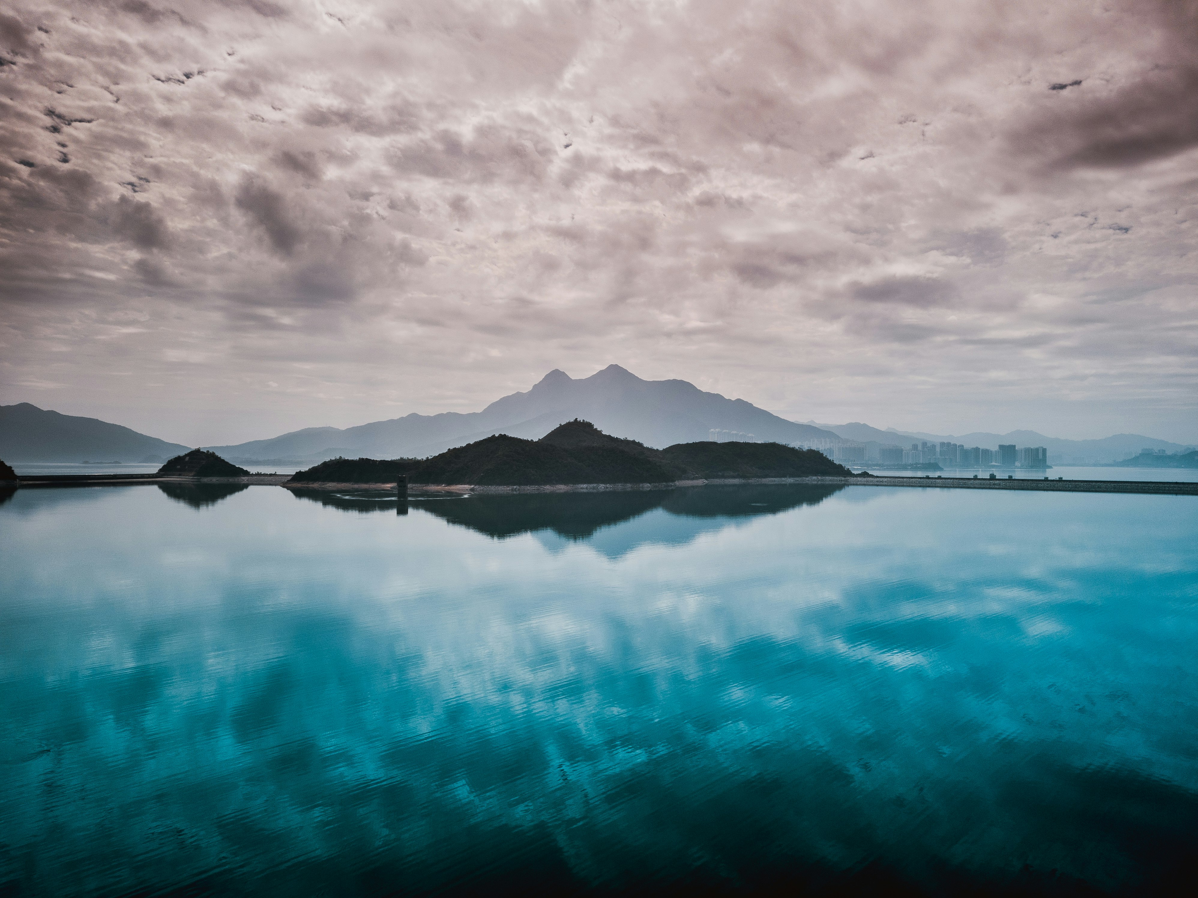 body of water under grey sky