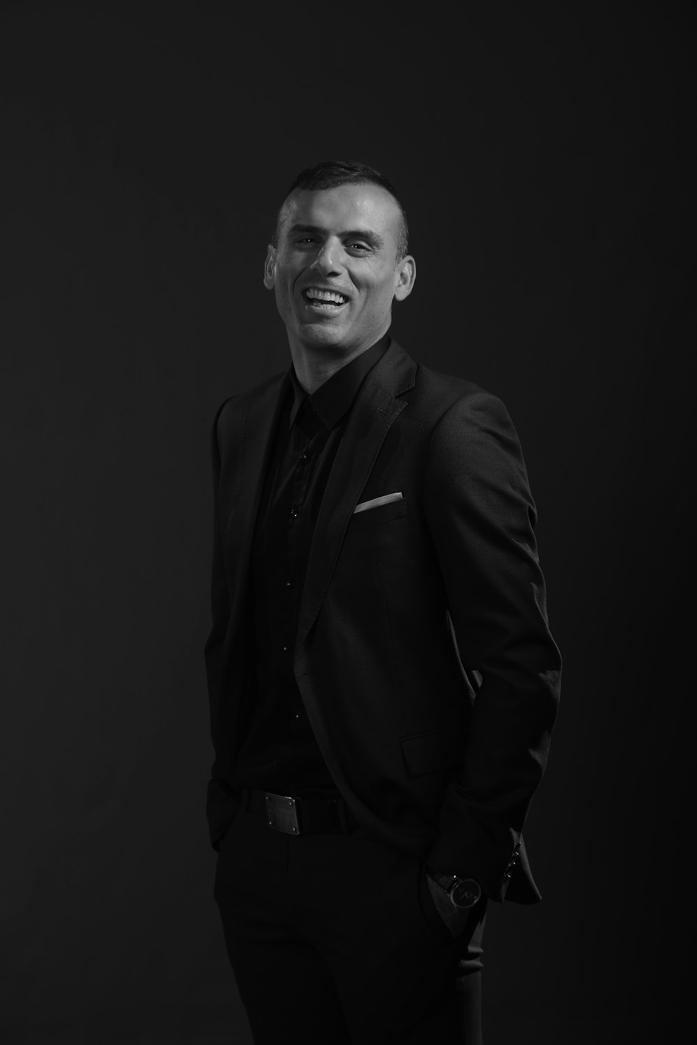 grayscale photography of man wearing black tuxedo