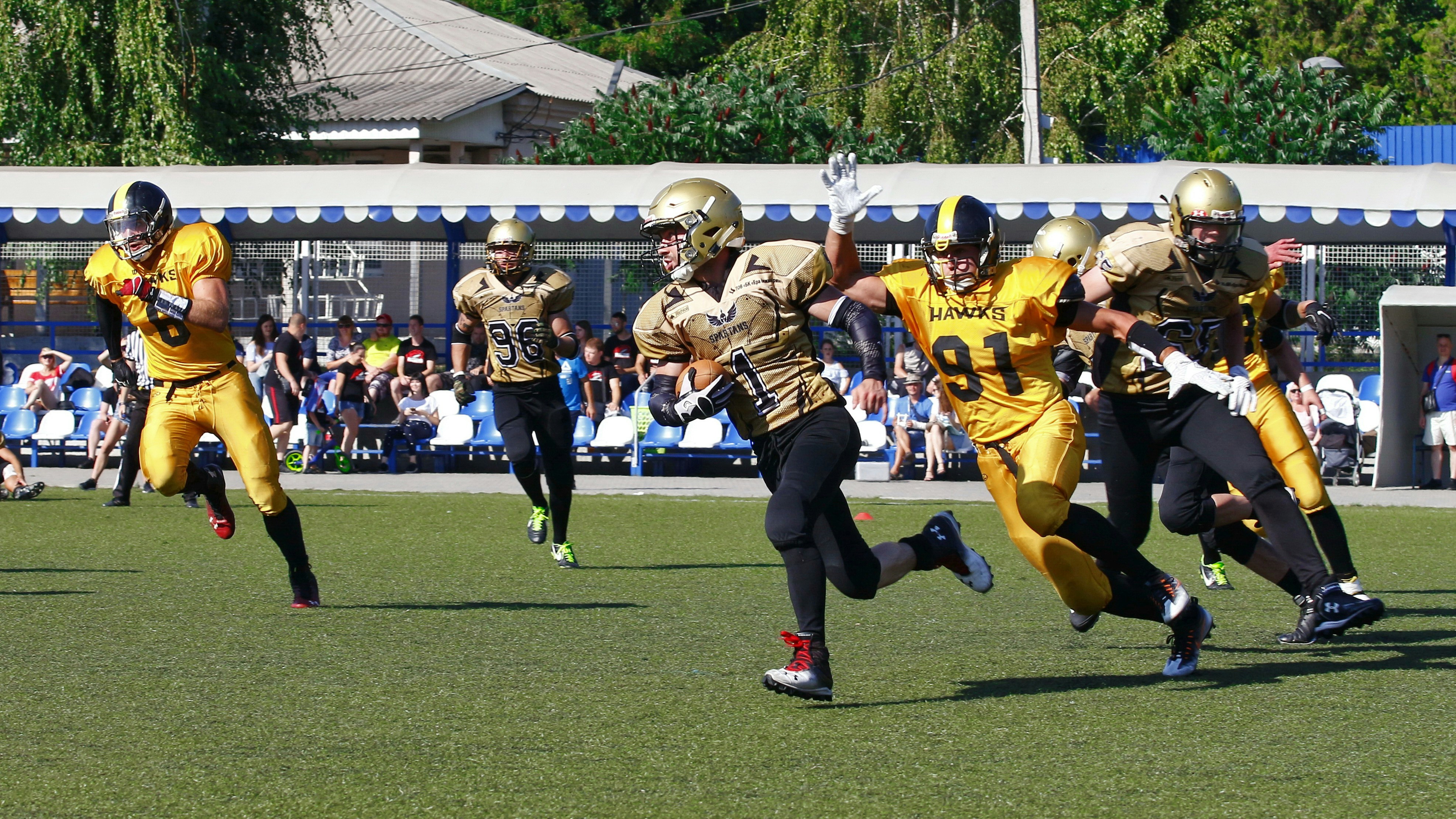 men playing football at stadium
