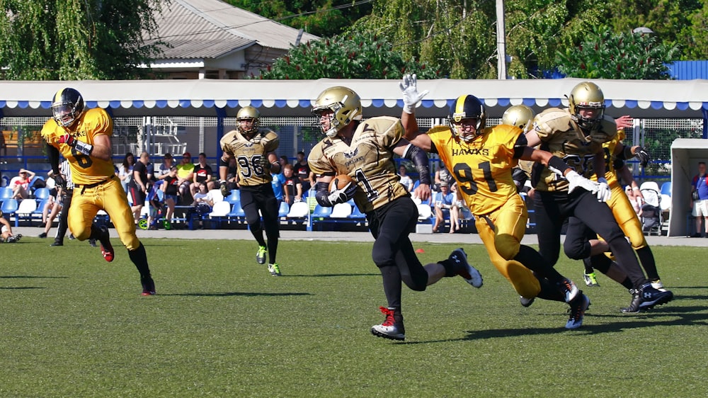 men playing football at stadium