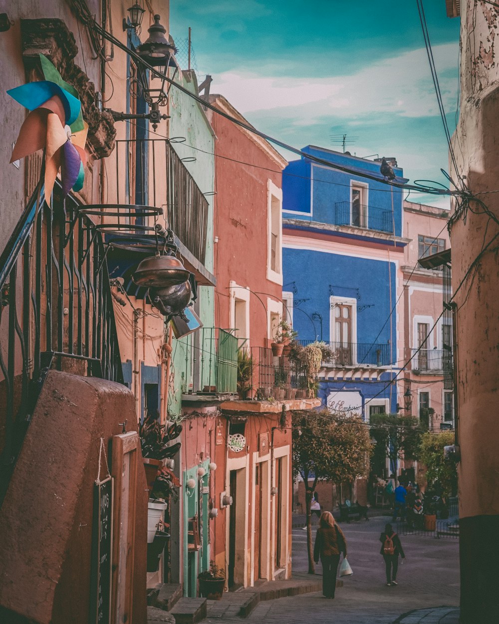 people walking near houses during daytime