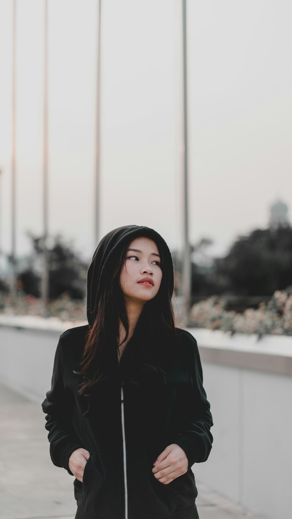 woman wearing black hooded jacket standing outdoor