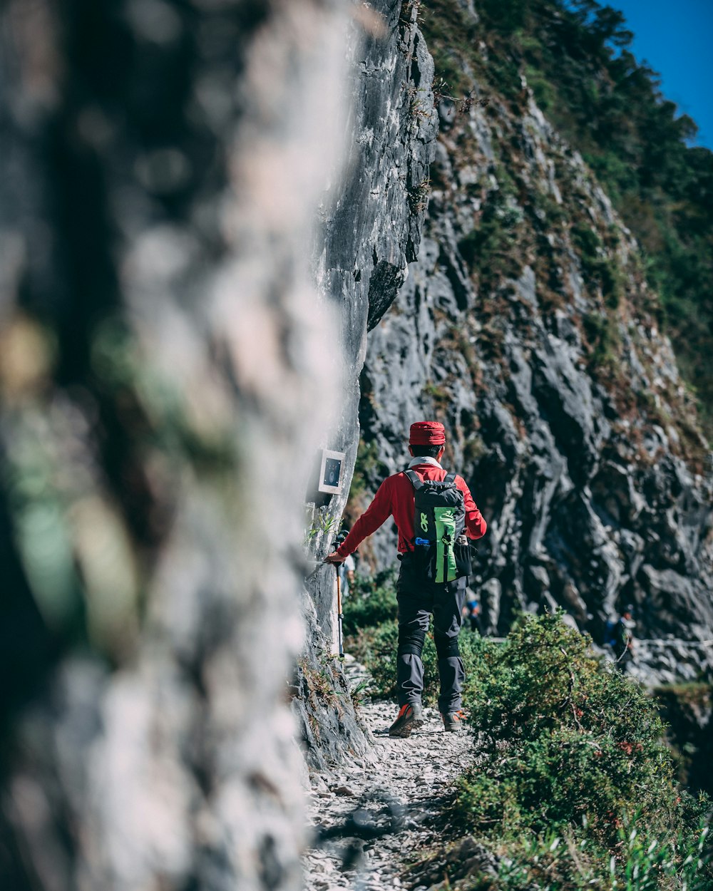 man walking near gray cliff