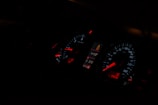 A car dashboard illuminated with digital security alerts from the Veloguard system.