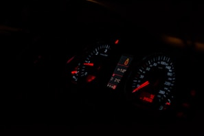 A car dashboard illuminated with digital security alerts from the Veloguard system.
