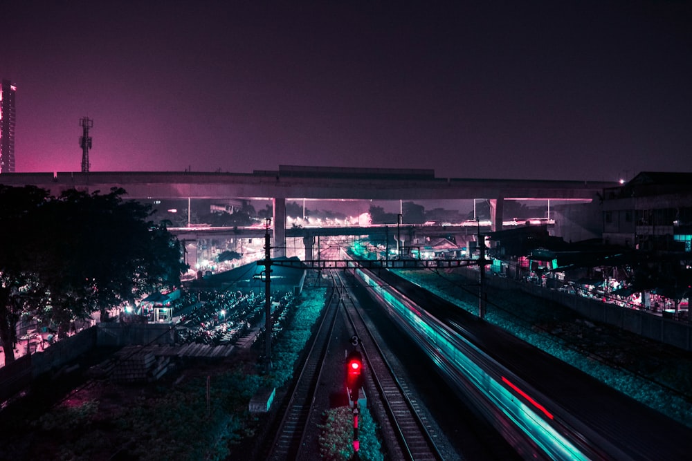 lighted train rail way during nighttime