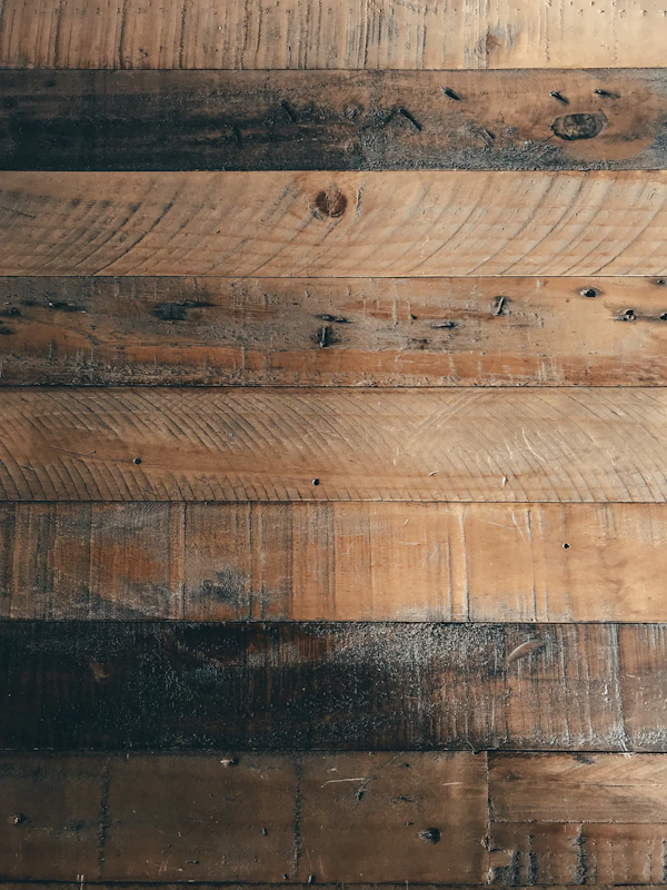 Reclaimed wood shelving unit mounted on a white wall