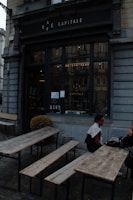 A cozy café terrace with travelers enjoying coffee and conversation.