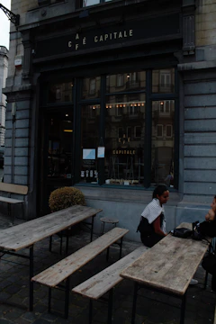 A cozy café terrace where travelers share stories over warm drinks.
