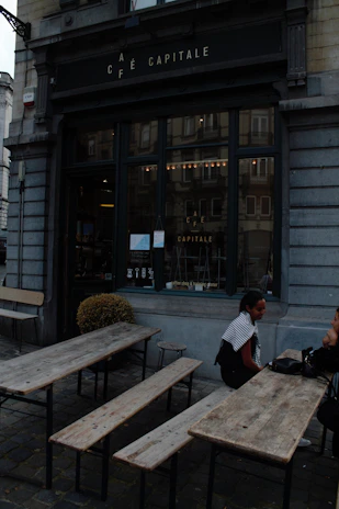 A cozy café scene with a consultant discussing plans with a small business owner.