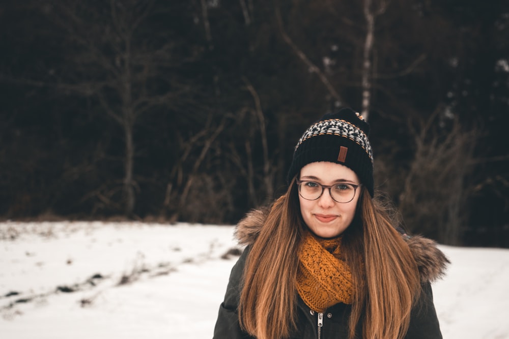 woman standing on snow-covered field