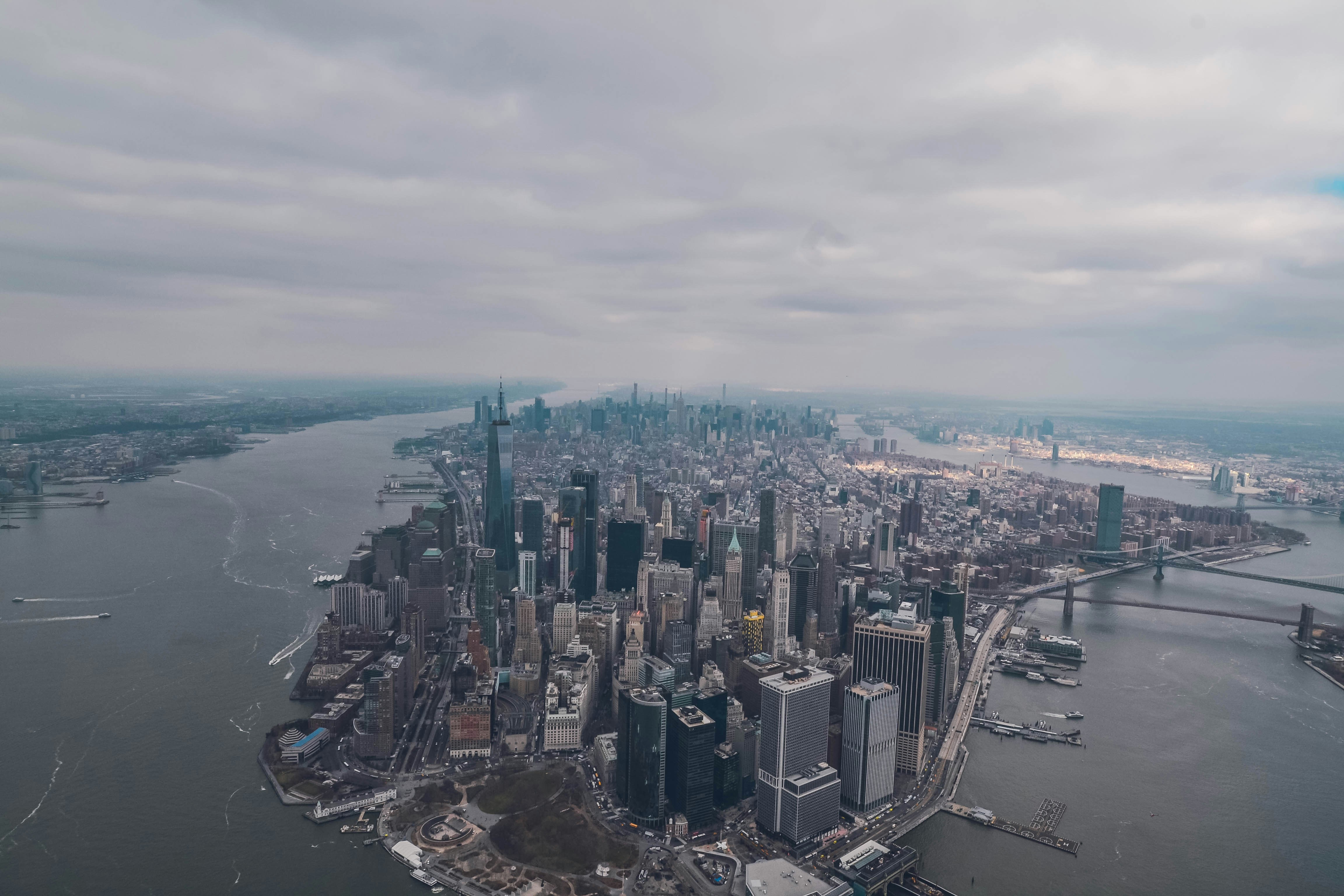 aerial photo of high rise buildings surrounded by sea during daytime