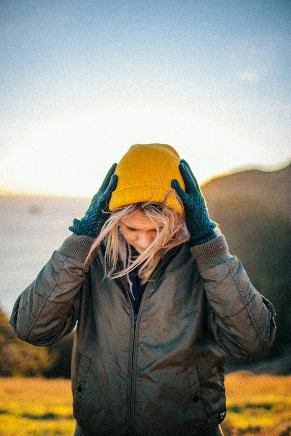 girl wearing yellow knit cap during daytime