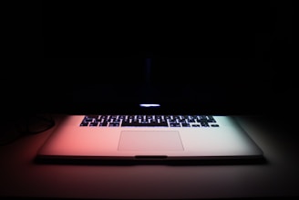 gray laptop computer on black surface