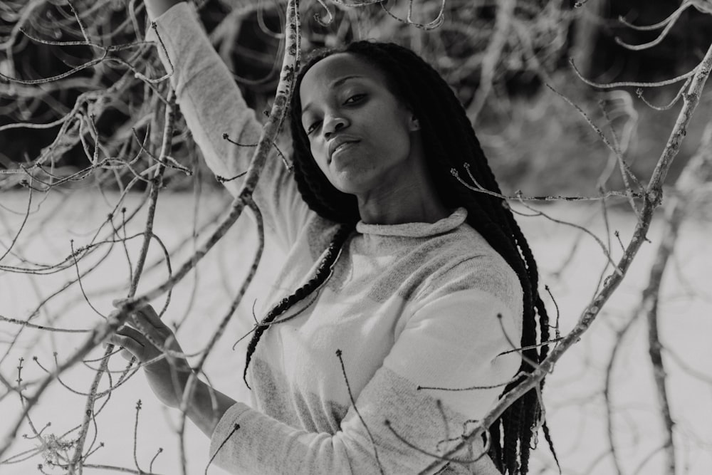 grayscale photo of woman in white long-sleeve shirt