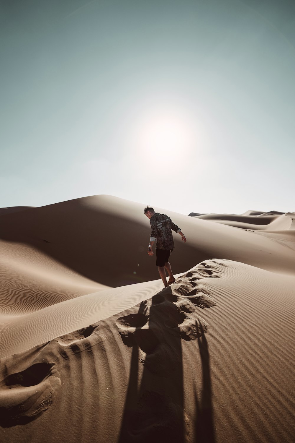 man standing on desert at daytime