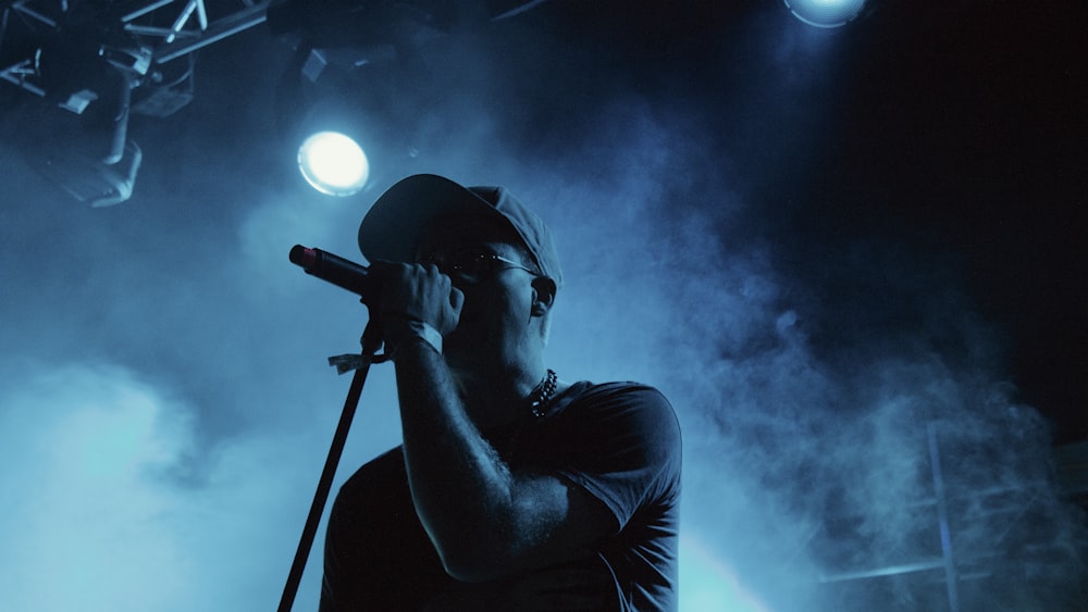 man singing on stage