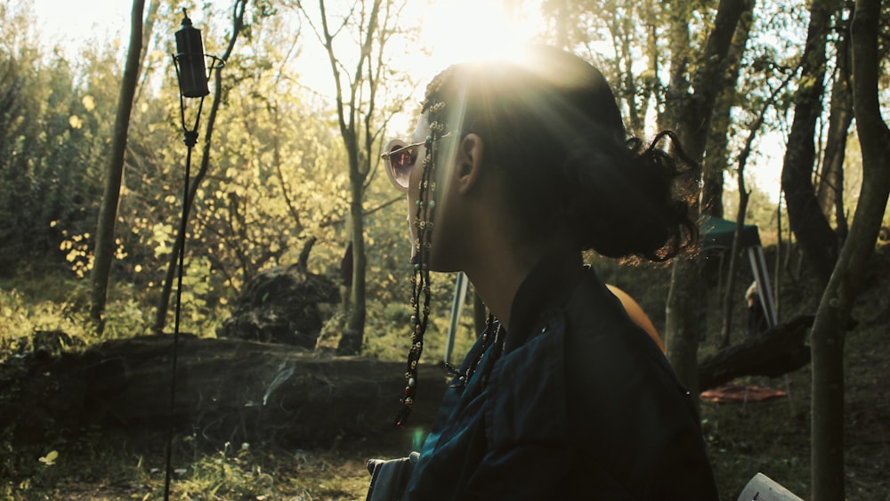 a person standing in a forest with trees