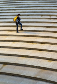 person stepping on stairs at daytime