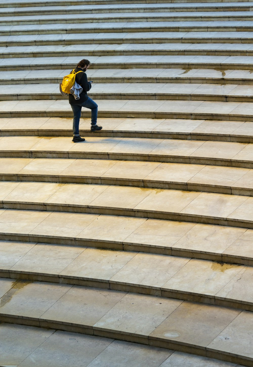 person stepping on stairs at daytime