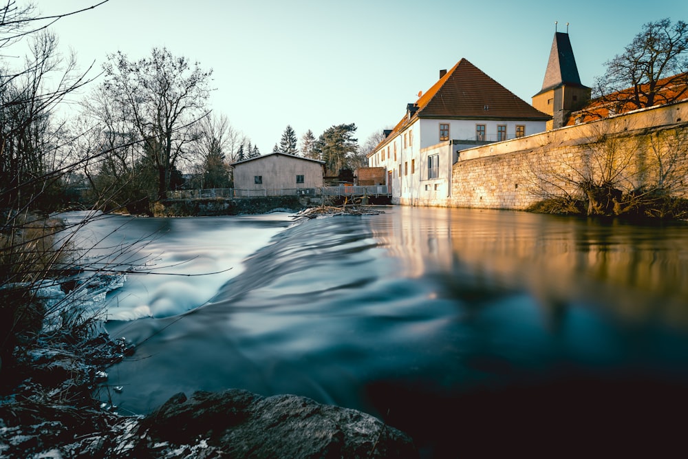 white concrete house beside river