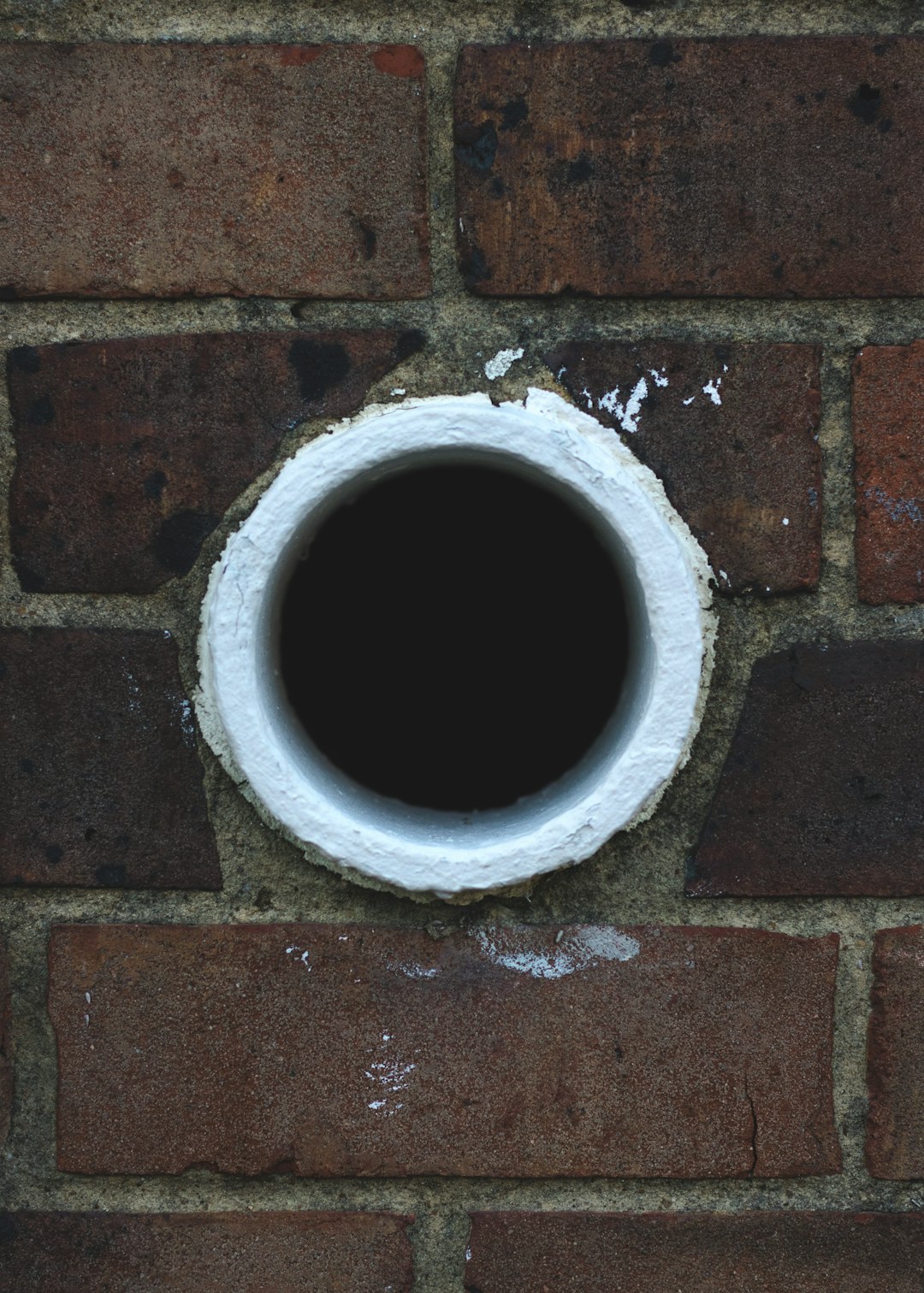 white hole in brick wall