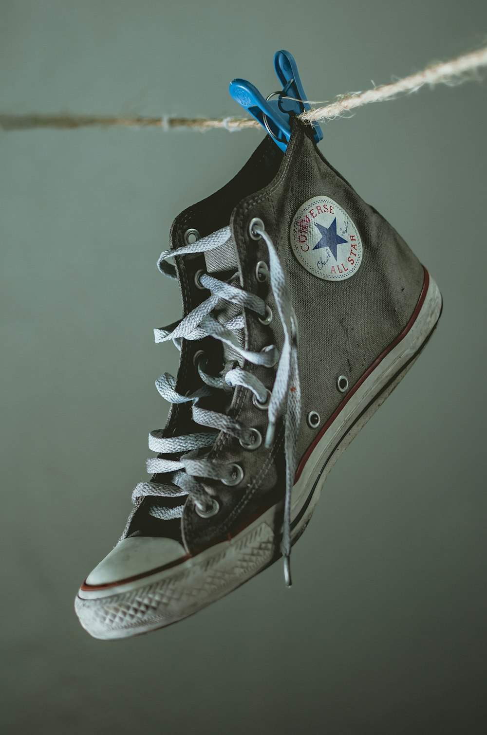 hanged brown and white Converse All Star high-top sneaker