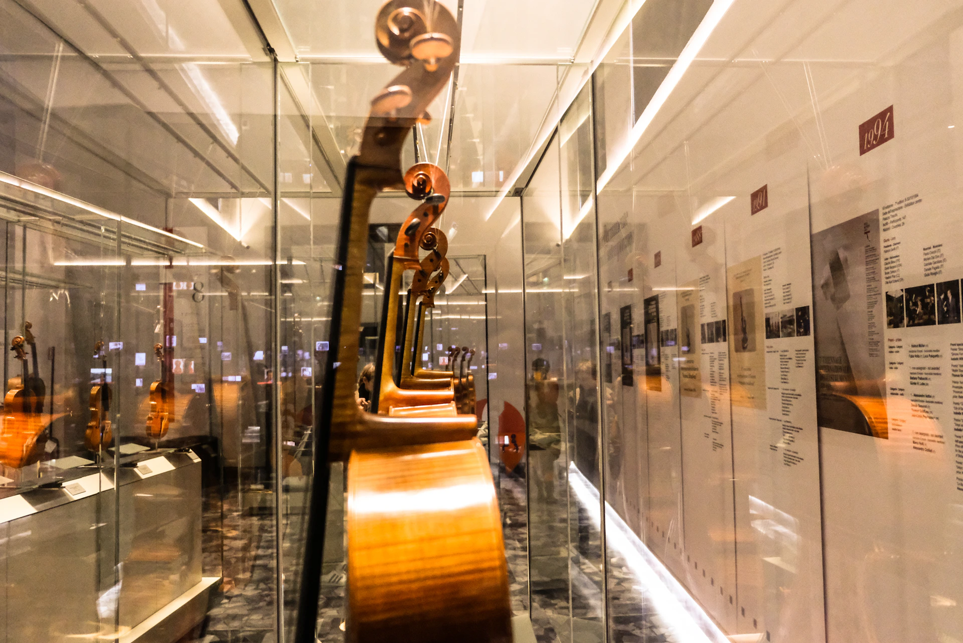 An elegant display of antique musical instruments, softly lit to highlight their craftsmanship and historical significance.