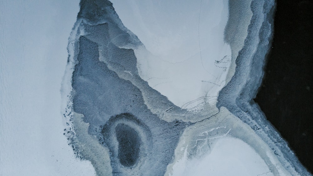 an aerial view of a river with ice on it