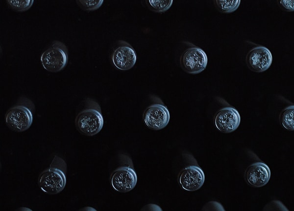 close-up photography of glass bottles with lid