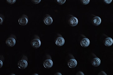 close-up photography of glass bottles with lid