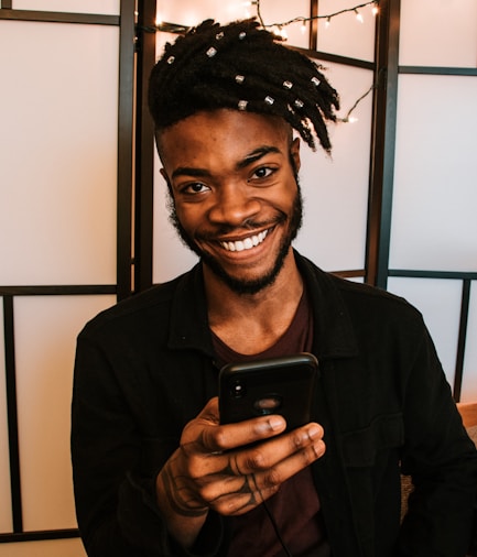 smiling man using smartphone