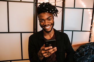 smiling man using smartphone
