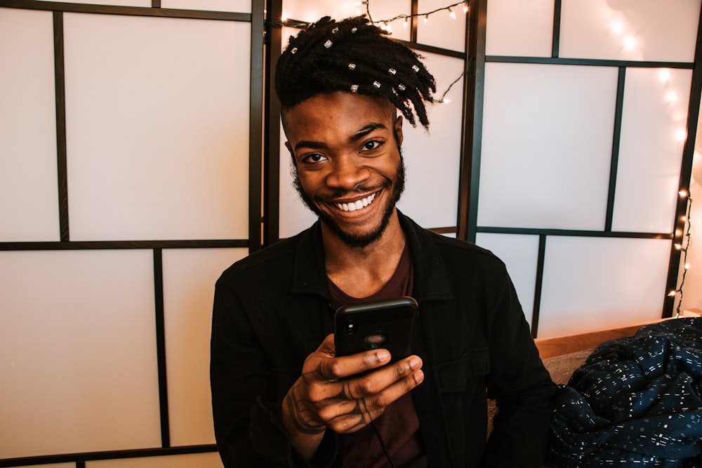 smiling man using smartphone