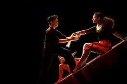 Group of flamenco artists improvising together on stage, sharing a moment of spontaneous connection.