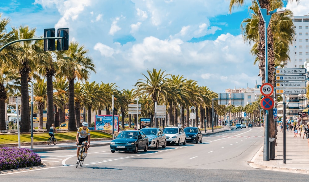 man riding on bike with vehicle behind