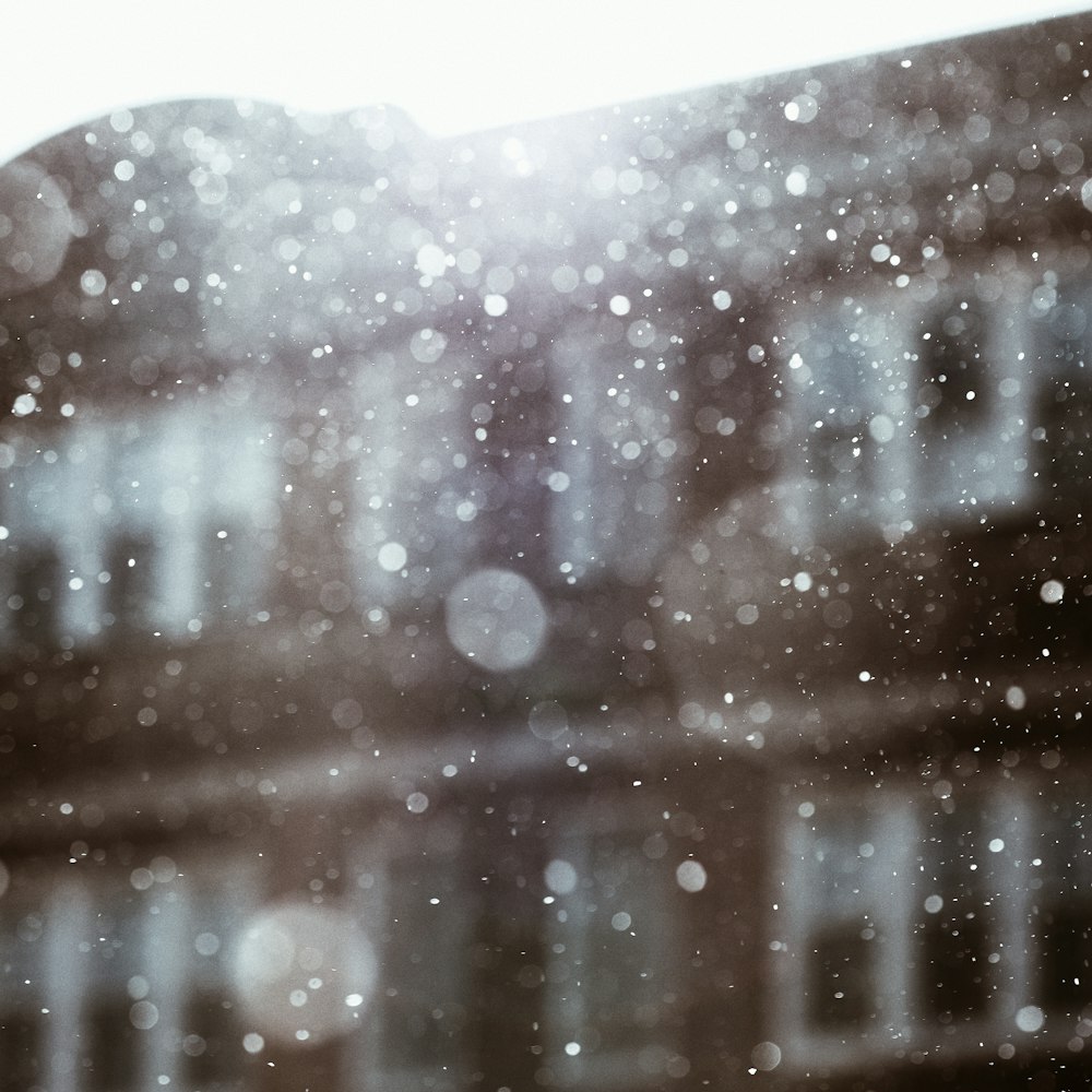 a blurry photo of a building with snow falling on it