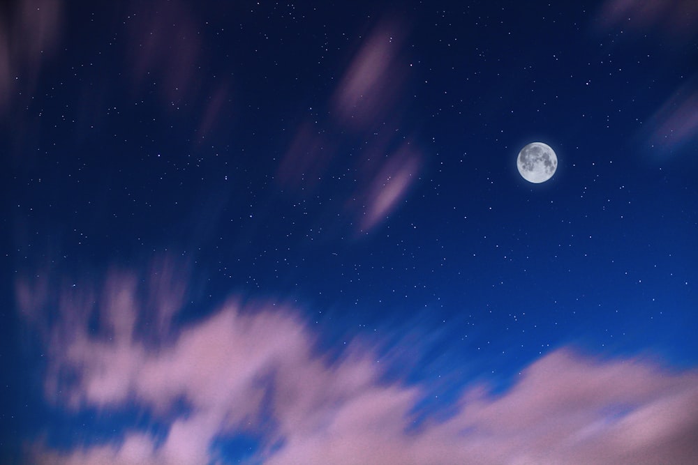 full moon in blue sky during dawn