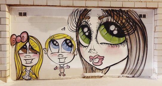 The image features a vibrant mural depicting three stylized cartoon characters with exaggerated features such as large eyes and big smiles. The characters are painted on a white tiled wall, adding a playful and whimsical vibe.