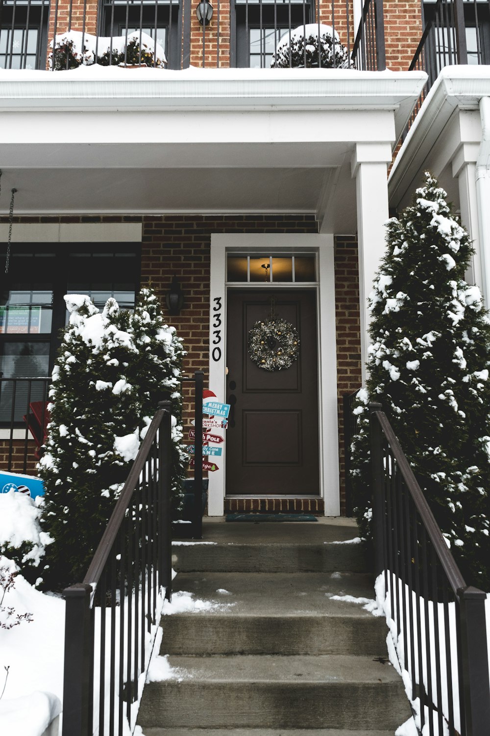 snow covering on trees and house