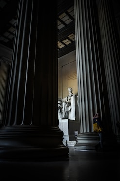 man sitting on armchair statue