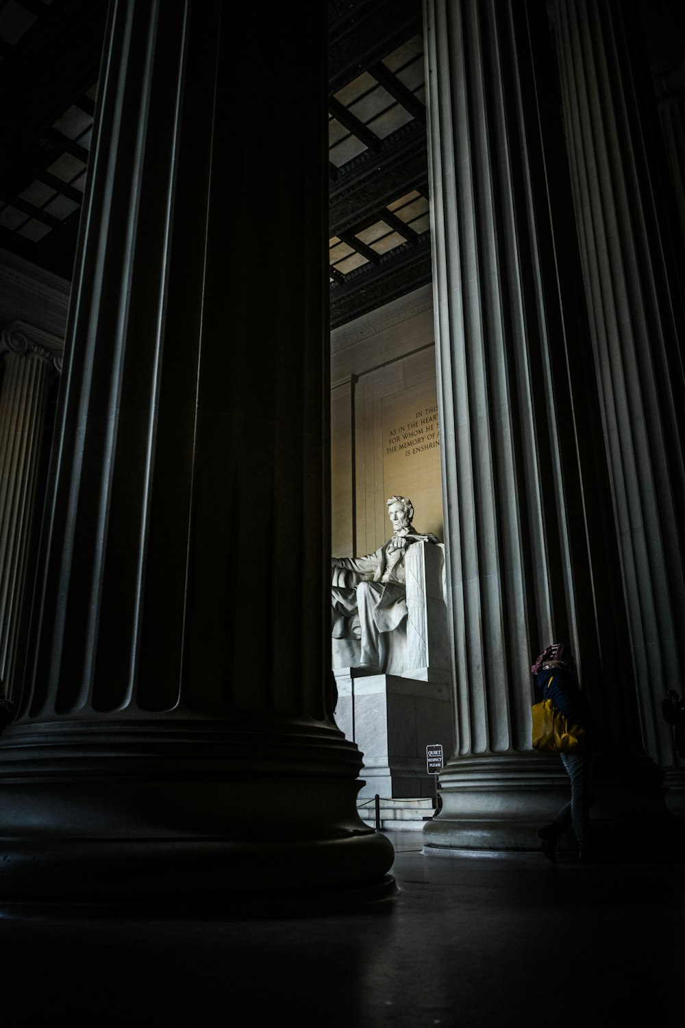 man sitting on armchair statue