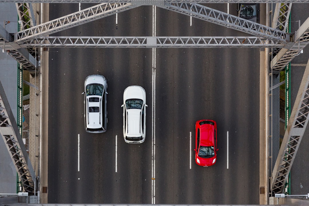 aerial photo of three cars