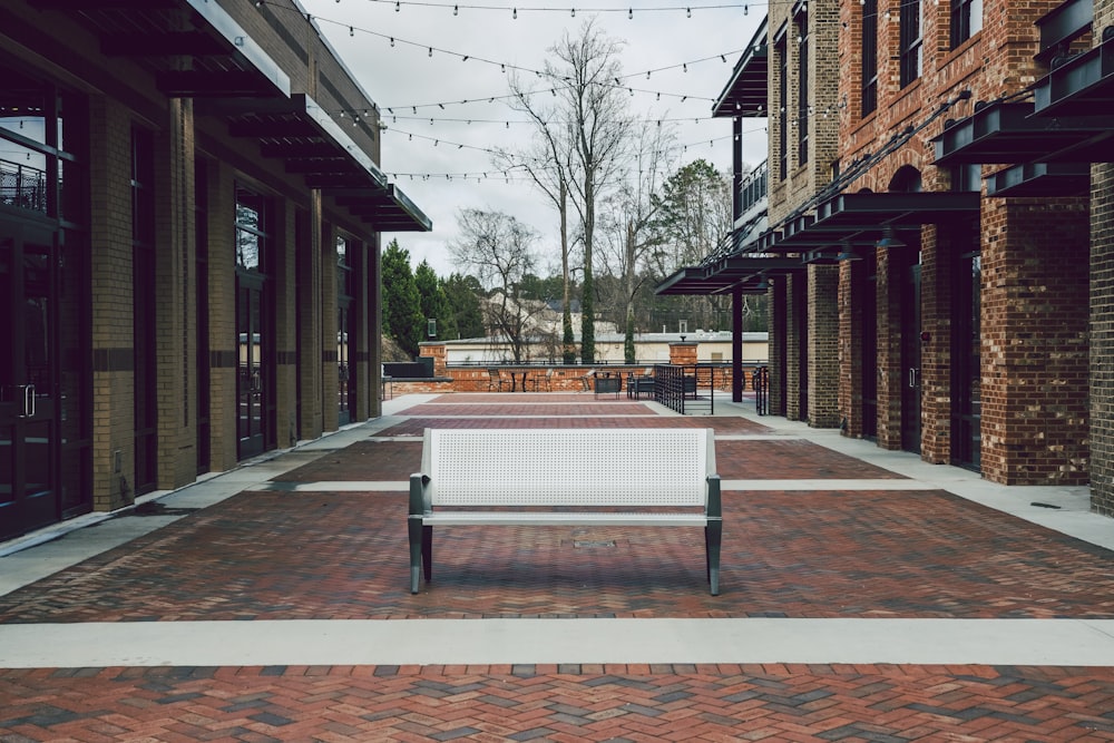 white bench between buildings