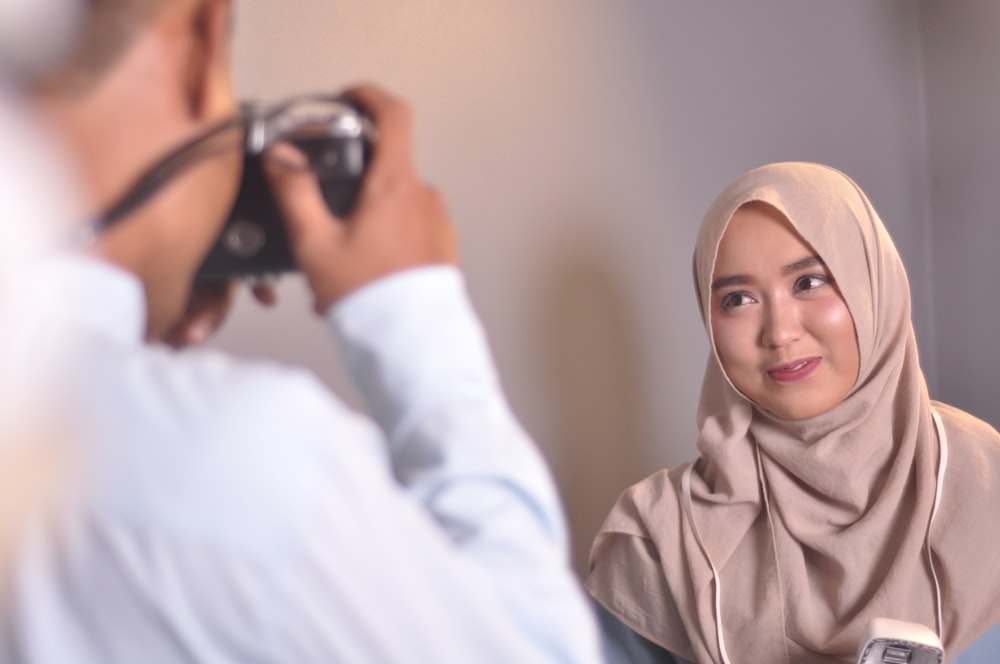 smiling woman near man using camera \]