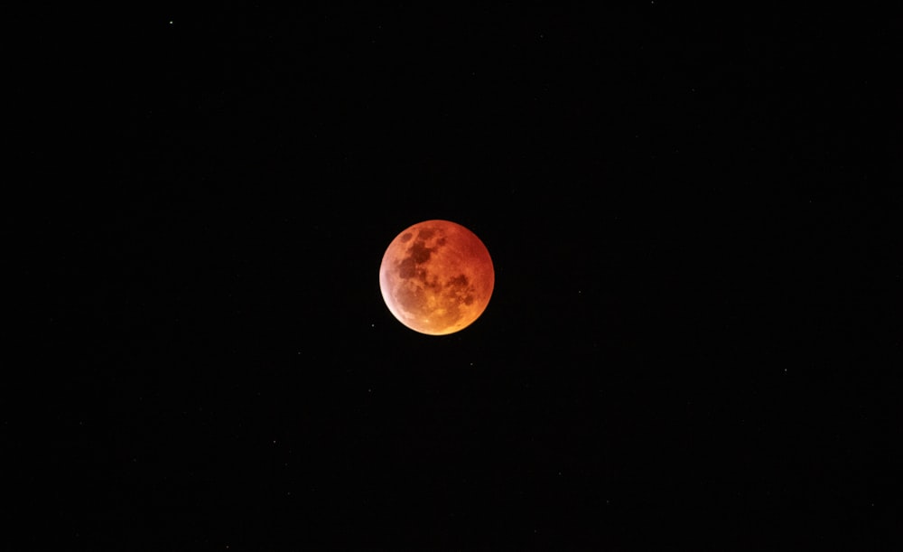 blood red full moon in dark sky