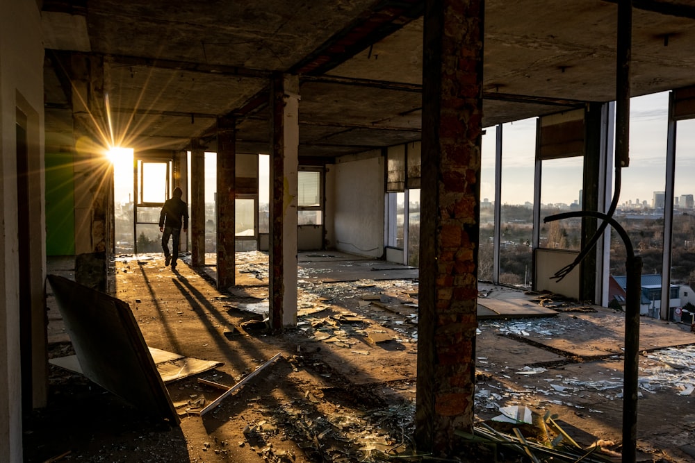 man walking inside broken building