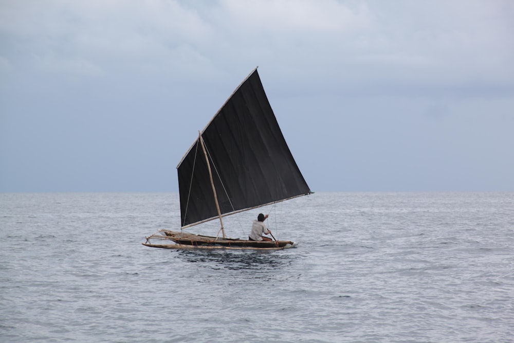 person riding on sailboat during daytime