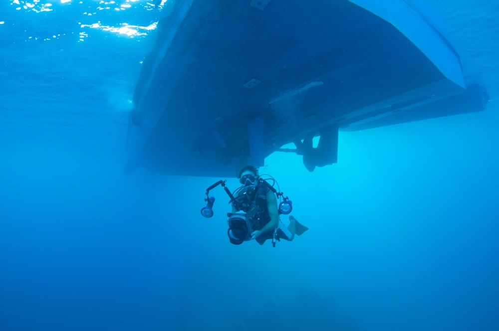 underwater photography of person holding camera